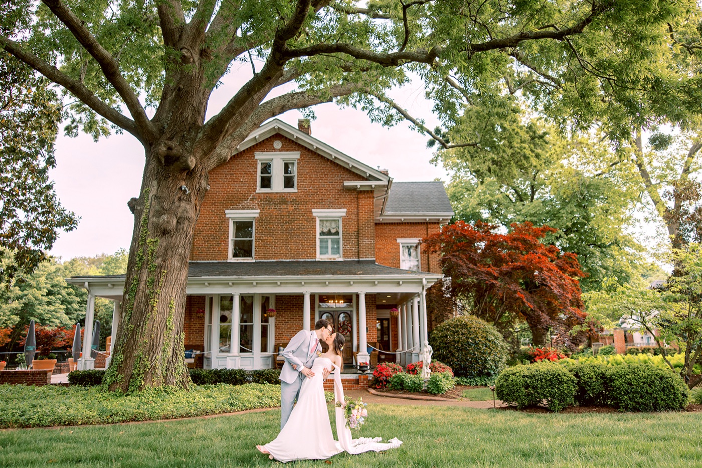 The historic brick Manor beneath its mature trees