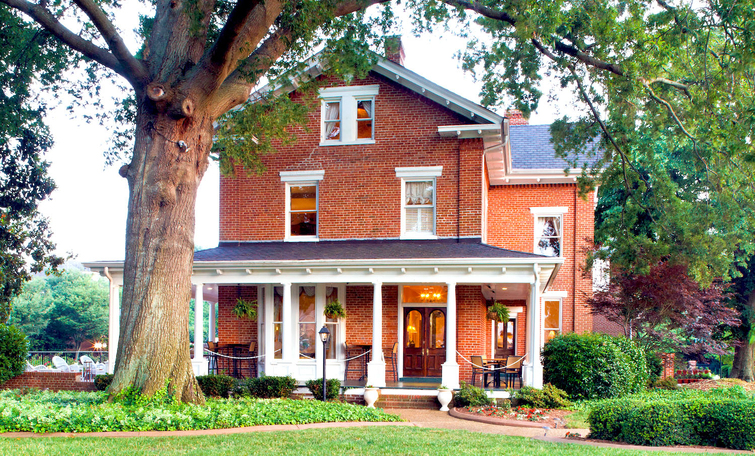 The historic Church Point Manor surrounded by gardens and oak trees
