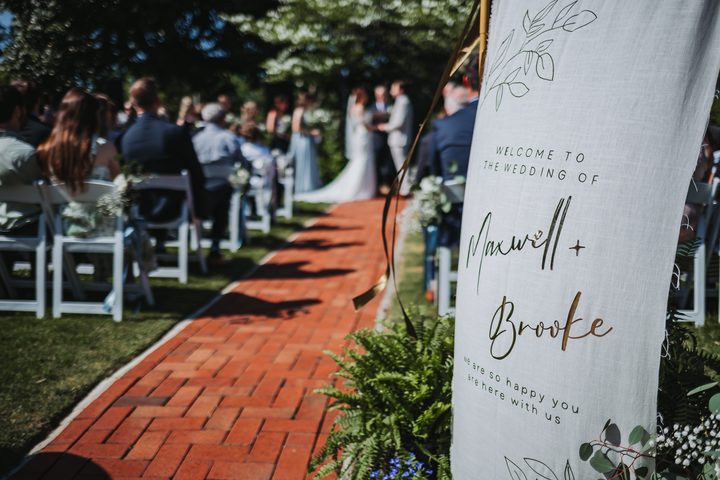 Brooke and Max’s welcome sign beside the ceremony aisle