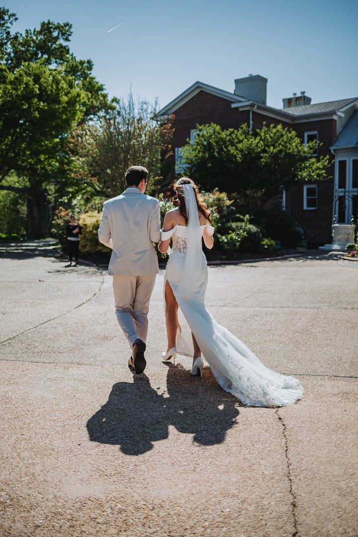 Brooke and Max walking hand in hand after their ceremony