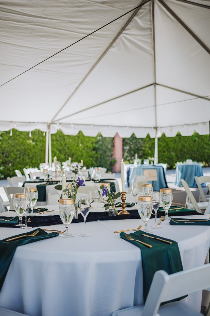 Reception tables arranged beneath the white tent