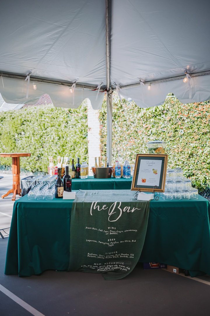 The guest book and welcome table beneath the reception tent
