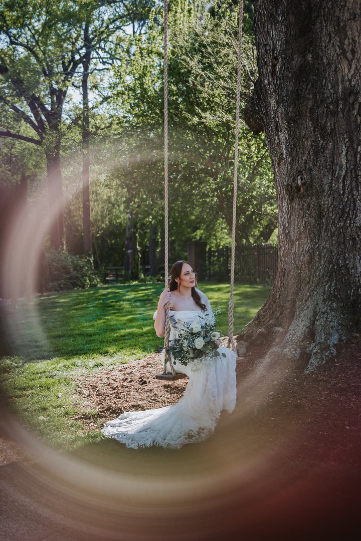 Brooke on the oak-tree swing, framed through a wedding ring