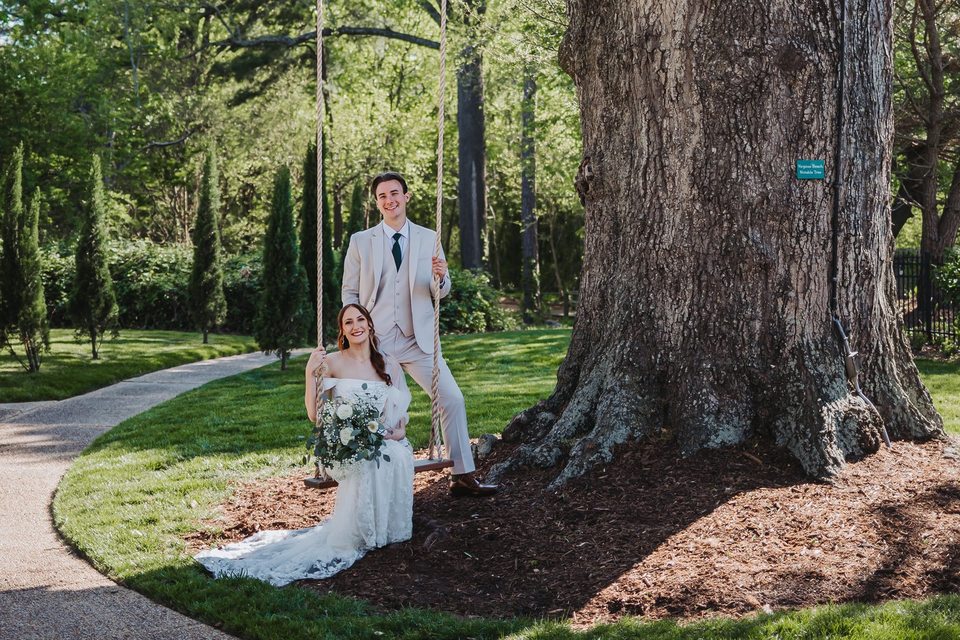Brooke and Max together on the garden swing beneath the old oak at Church Point Manor