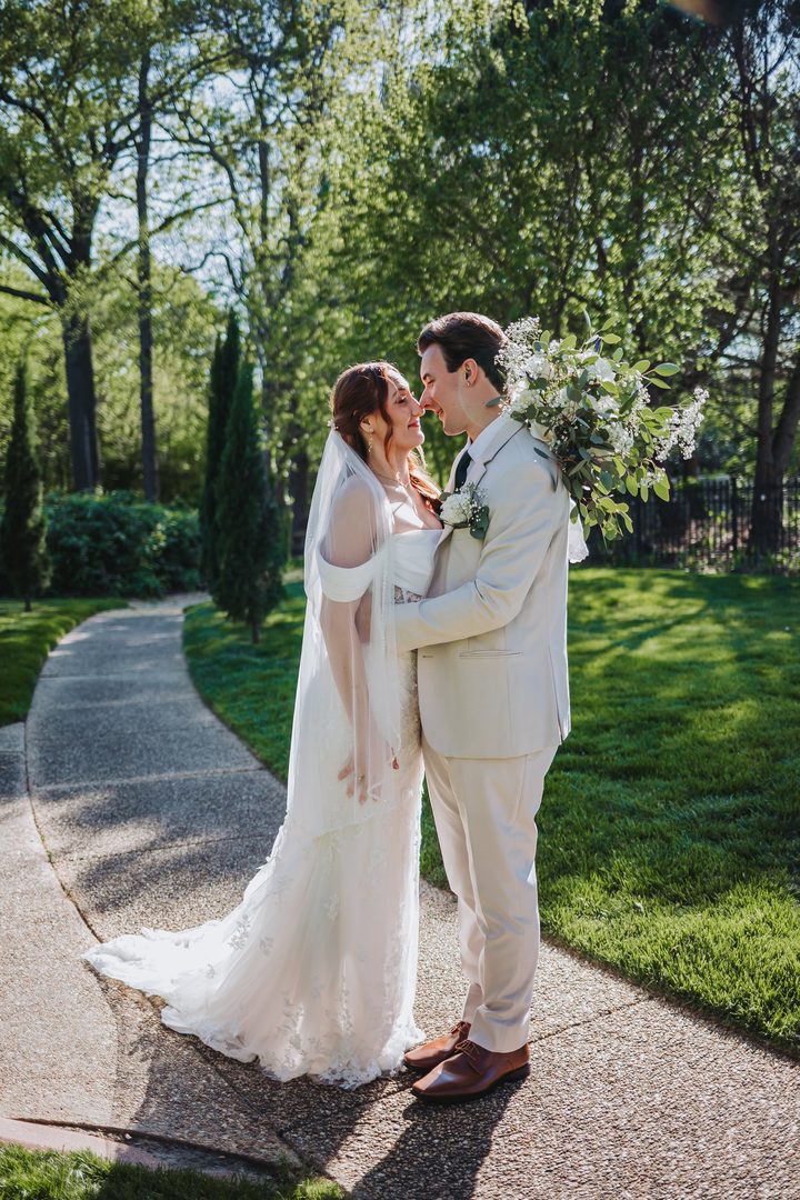 Brooke and Max sharing a kiss on the garden path