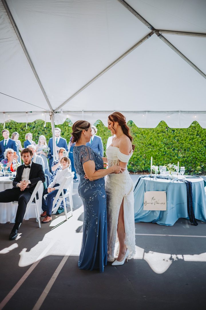 Brooke and her bridal party celebrating beneath the white tent