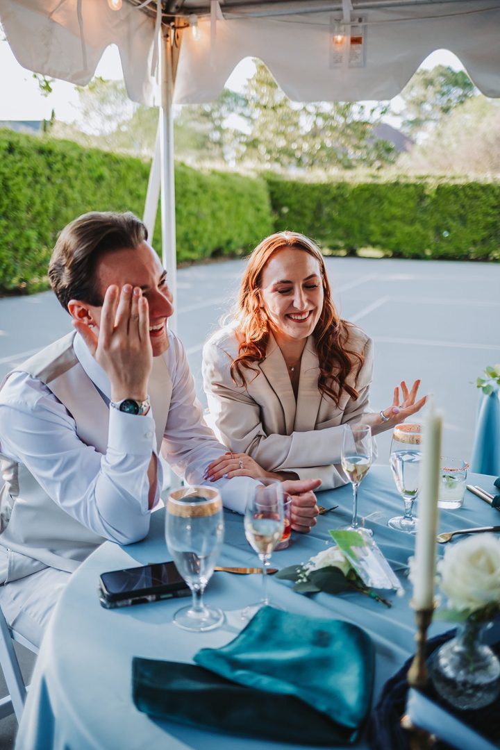 Brooke and Max laughing during the wedding reception