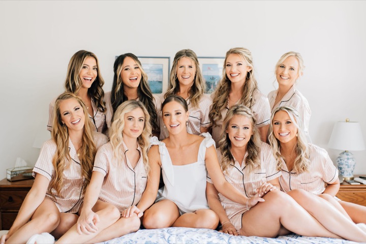 The bridal party sitting together in the blue toile bedroom