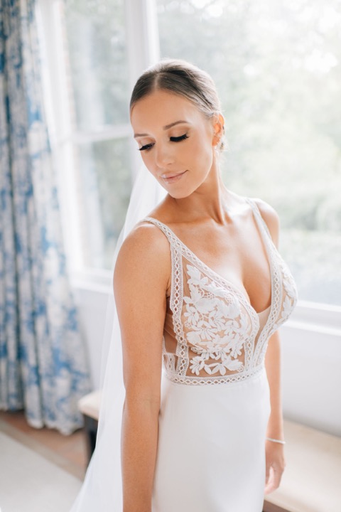 Sarah standing beside the blue toile curtains