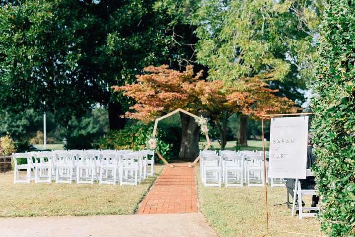 The autumn ceremony arbor and white chairs in the garden