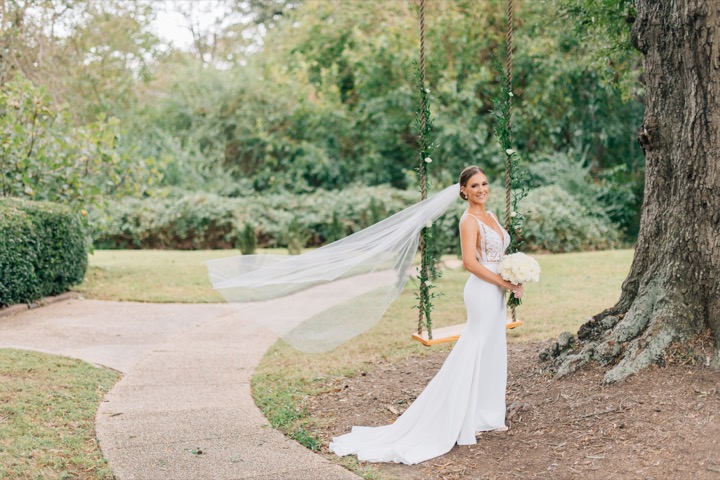 Sarah and her long veil beside the old oak