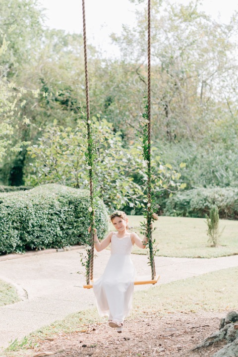 Sarah seated on the garden swing