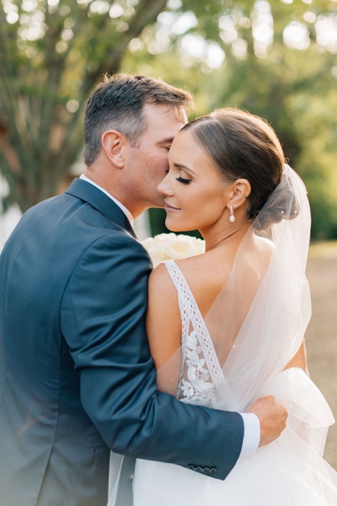 The newlyweds embracing in the afternoon light