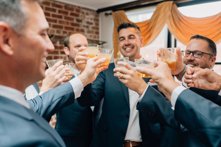 The groom and his friends raising a toast in the Cellars