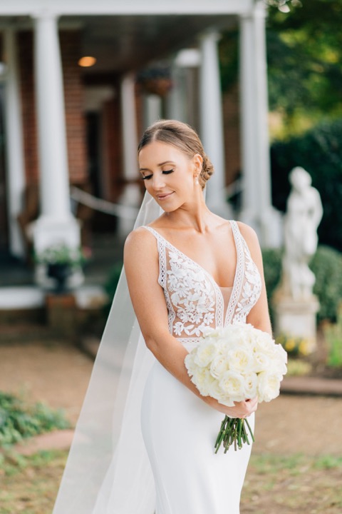 Sarah with her bouquet beside the Manor porch