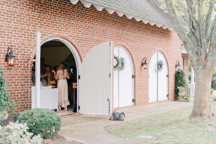 The bridal party emerging through the Carriage House doorway