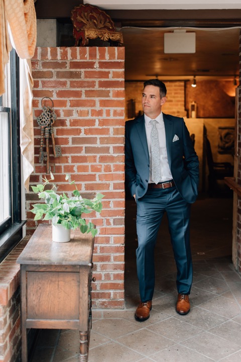 The groom standing in the Cellars doorway