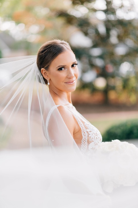 Sarah looking back through her veil in the garden