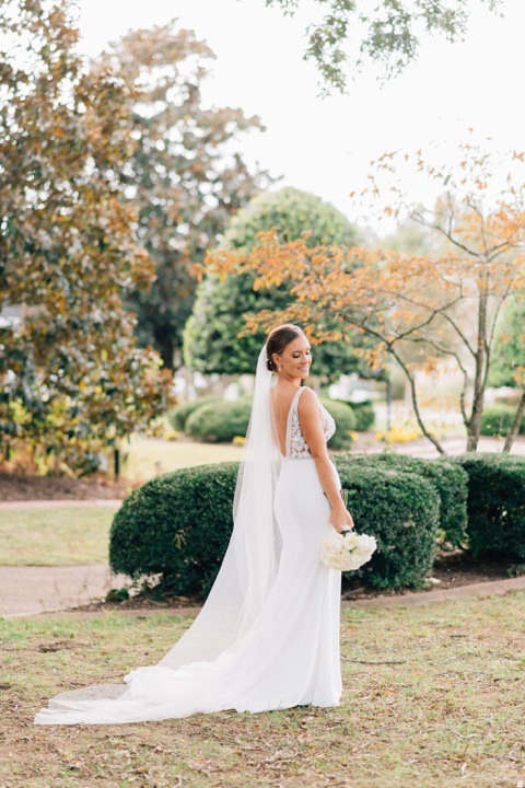 Sarah and her veil on the garden lawn
