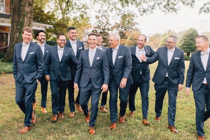 The groom and his wedding party lined up in the gardens