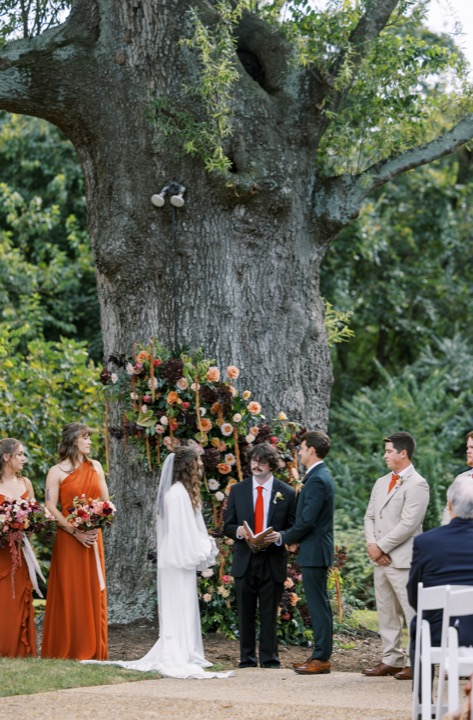 Madelynne and Parker exchanging vows under the oak tree