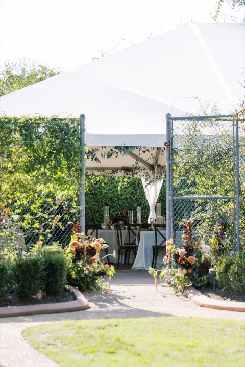 A garden entrance leading into the reception tent
