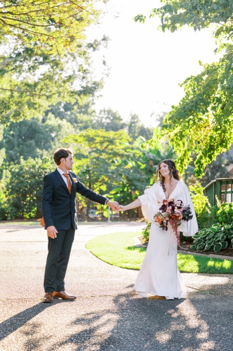 Parker holding Madelynne’s hand on the garden path