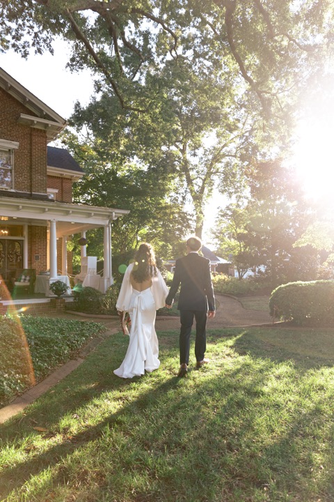 Golden sunlight falling across the couple on the Manor lawn