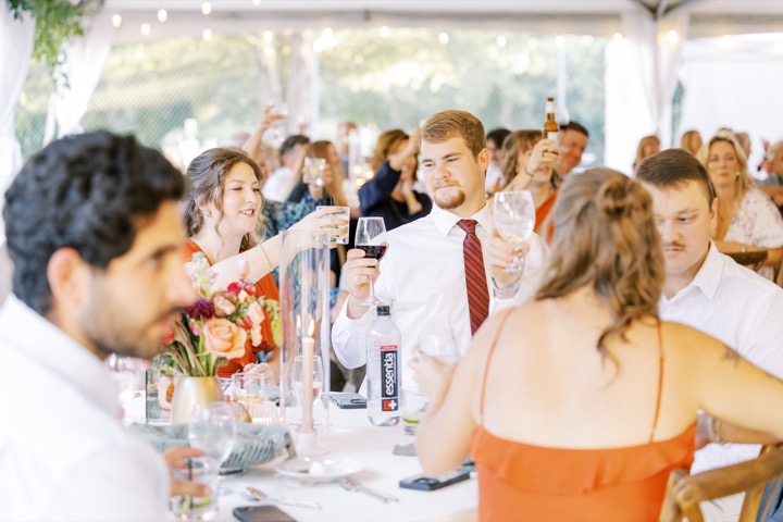 Guests raising their glasses during the wedding reception