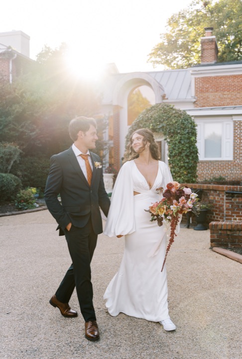Madelynne and Parker walking together through the sunlit courtyard