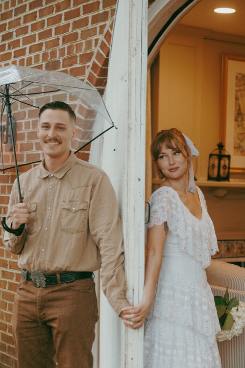 Casey and Kali holding hands by the Carriage House doorway