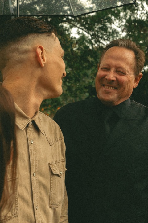 Casey smiling with a guest in the garden