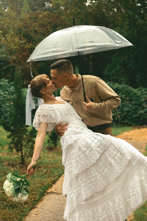 Kali twirling beside Casey under an umbrella