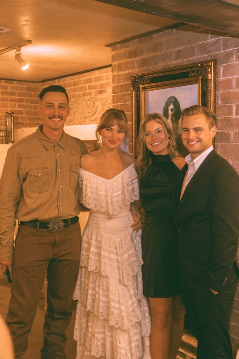 The couple posing with guests in the Cellars