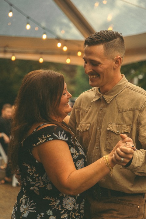 Casey dancing with a guest at the reception