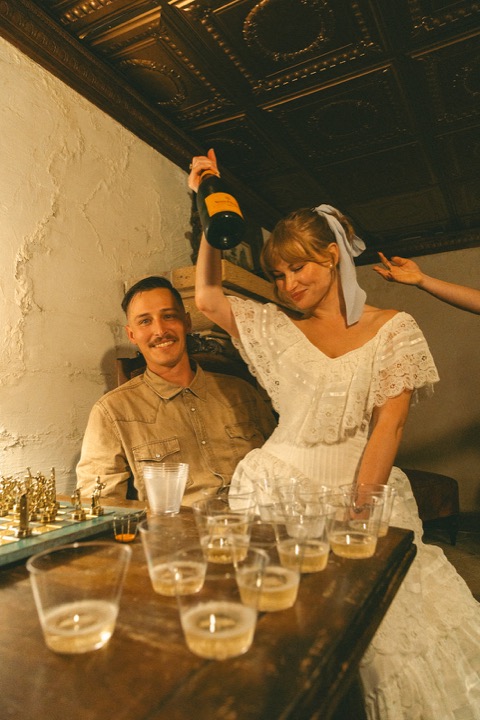 Casey and Kali beside a table of champagne glasses