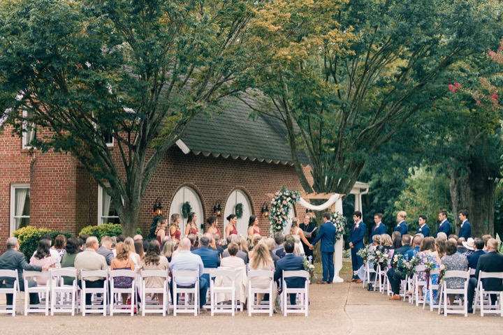 Wedding guests watching the ceremony in the Carriage House garden