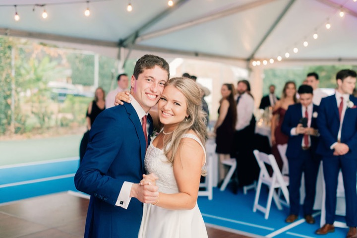 Tyler and Kate smiling together at their reception
