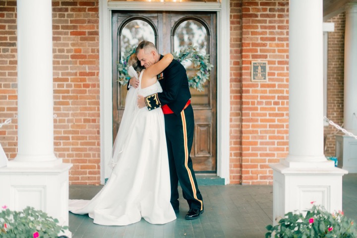 The couple sharing a kiss by the Manor’s front doors