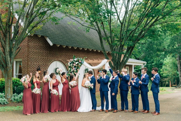 The wedding party celebrating outside the Carriage House