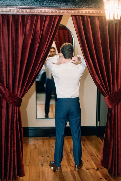 Tyler getting ready beside the Cellars curtains