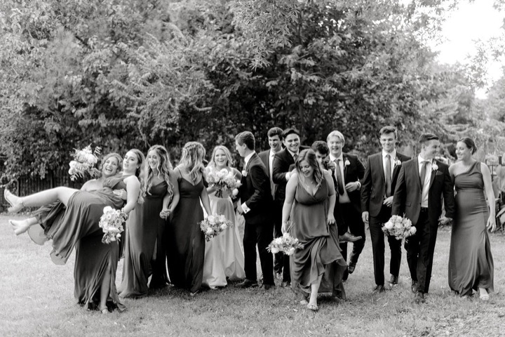 A black-and-white photograph of the wedding party in the gardens