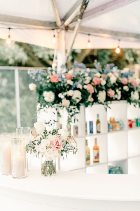 The reception flowers and candles beneath the tent