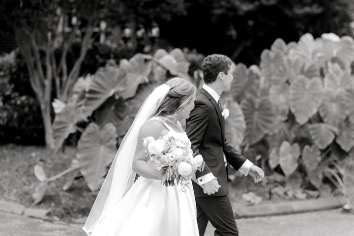 A black-and-white portrait of Tyler and Kate kissing in the gardens