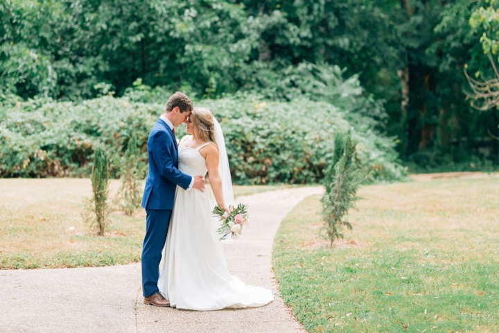 The newlyweds sharing a kiss on the garden lawn