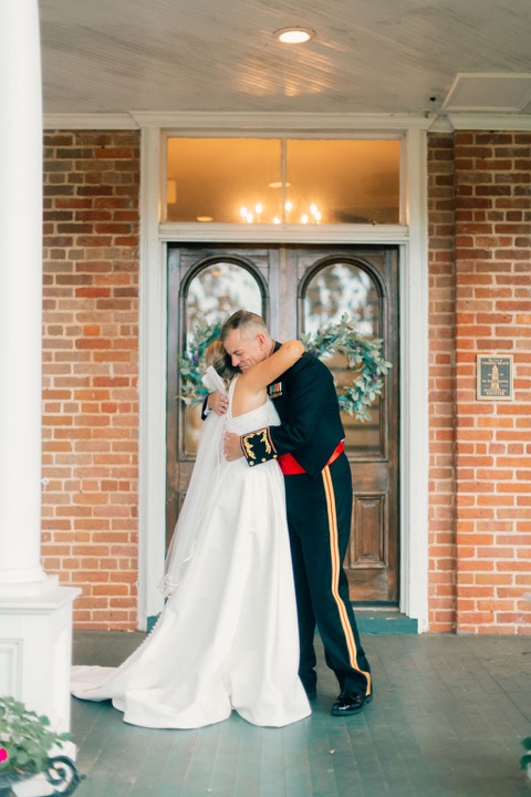 The couple embracing in front of the Manor’s doors