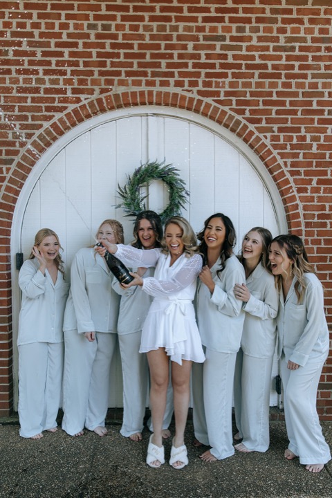 The bridal party in matching robes outside the Carriage House