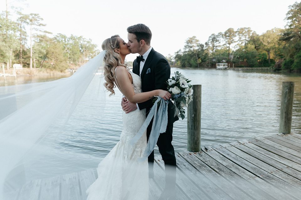 Taylor and John sharing a kiss on Church Point Manor’s waterfront dock