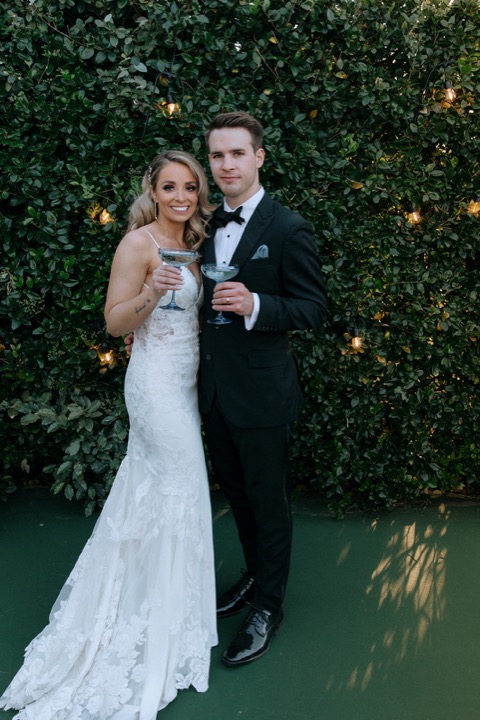 Taylor and John together in front of the garden greenery
