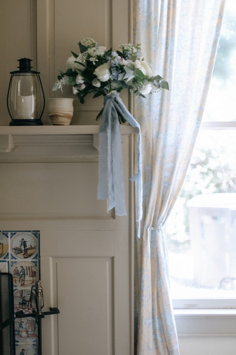 Flowers and ribbons beside a Carriage House window